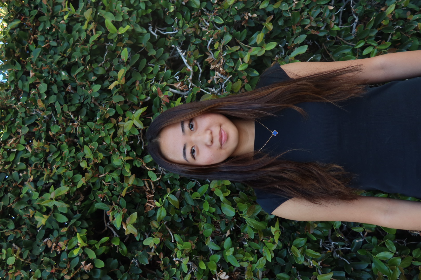 Portrait of Michelle Seo in front of green foliage