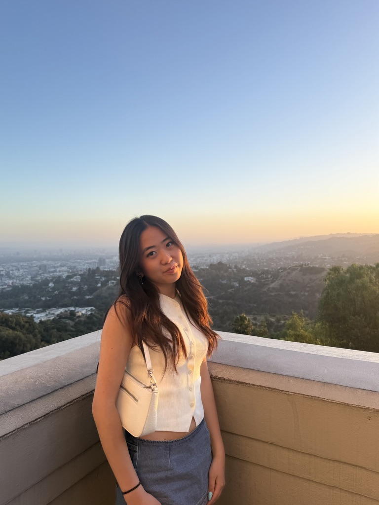 Michelle Seo outdoors at sunset, overlooking a city